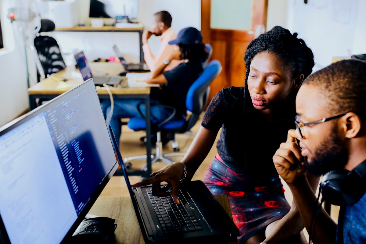 Engineers working together at a workstation